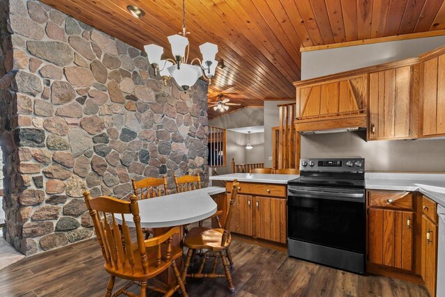 kitchen featuring light countertops, dark wood-style floors, ceiling fan with notable chandelier, and range with electric stovetop