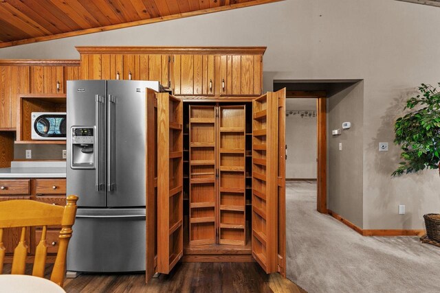 kitchen with high end fridge, wooden ceiling, lofted ceiling, and brown cabinets