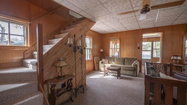 W13573 S Pleasant Rd, Westfield, WI 53964 - living room with carpet floors, stairway, wood walls, and a ceiling fan