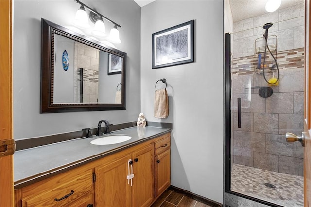 6825 W Lakewood Blvd, Ladysmith, WI 54848 - bathroom with vanity, a stall shower, and wood finished floors
