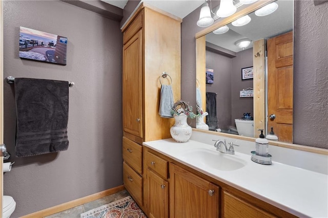 6825 W Lakewood Blvd, Ladysmith, WI 54848 - bathroom featuring toilet, vanity, and baseboards