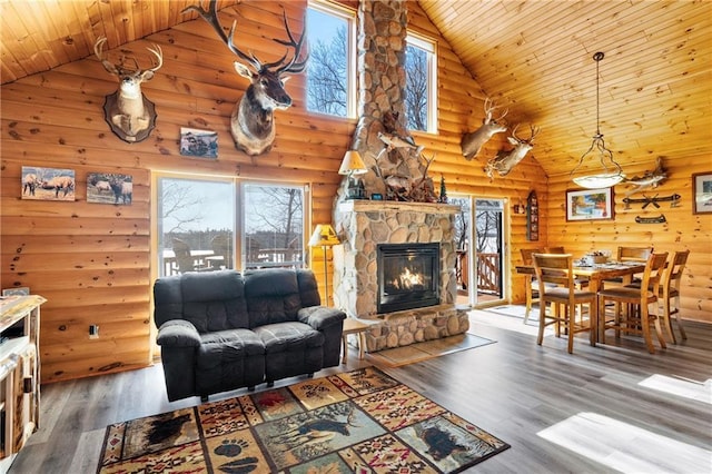 6825 W Lakewood Blvd, Ladysmith, WI 54848 - living room with high vaulted ceiling, log walls, a fireplace, wood finished floors, and wood ceiling
