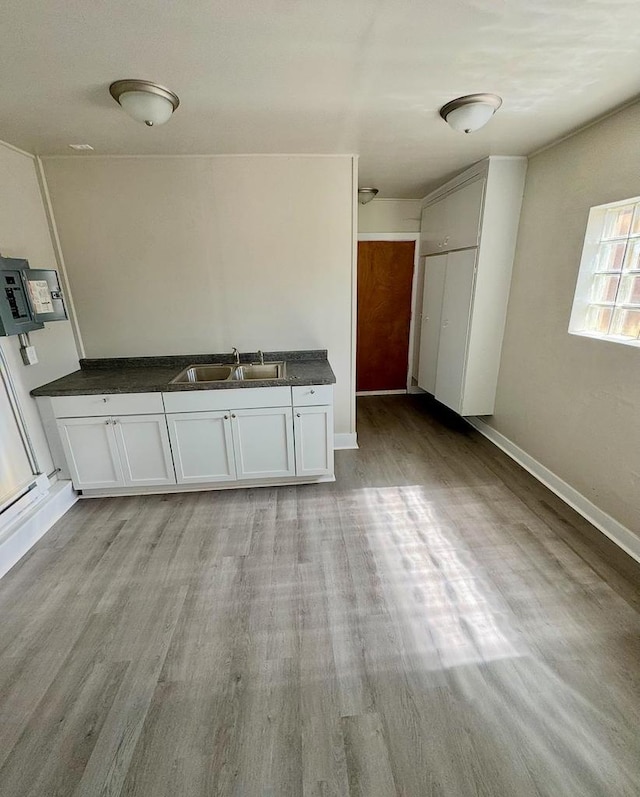 312 S Pearl St, New London, WI 54961 - interior space featuring baseboards, wood finished floors, and a sink