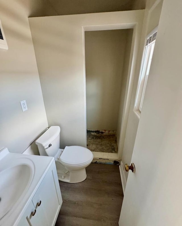 312 S Pearl St, New London, WI 54961 - full bathroom featuring toilet, vanity, a shower stall, and wood finished floors