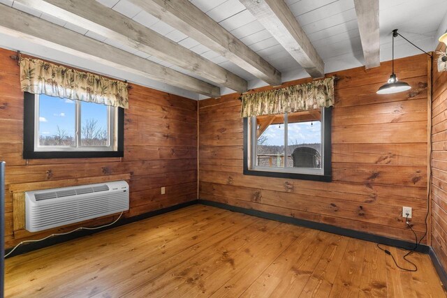 9614 Mississippi Ln, Bagley, WI 53801 - empty room featuring a wall mounted air conditioner, wood walls, hardwood / wood-style floors, and beam ceiling