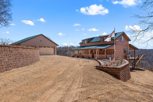 9614 Mississippi Ln, Bagley, WI 53801 - view of yard with dirt driveway, a detached garage, an outdoor structure, and a porch