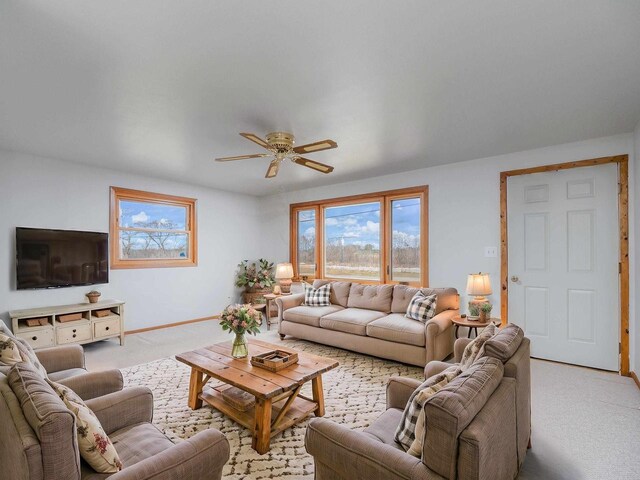 N6741 S Center Rd, Beaver Dam, WI 53916 - living area with light carpet, baseboards, and ceiling fan