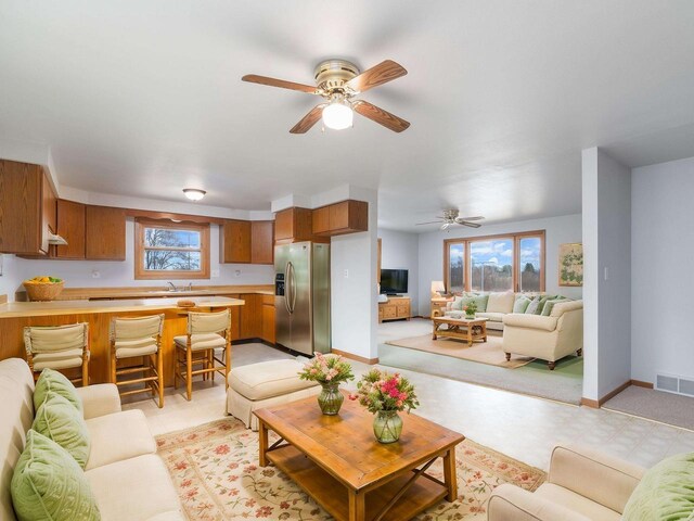N6741 S Center Rd, Beaver Dam, WI 53916 - living area with a ceiling fan, plenty of natural light, baseboards, and visible vents