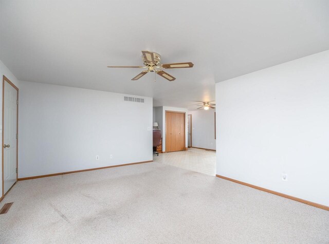 N6741 S Center Rd, Beaver Dam, WI 53916 - unfurnished room featuring light carpet, baseboards, visible vents, and ceiling fan