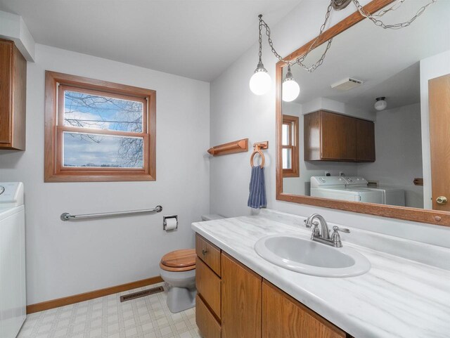 N6741 S Center Rd, Beaver Dam, WI 53916 - bathroom featuring independent washer and dryer, tile patterned floors, a healthy amount of sunlight, and visible vents
