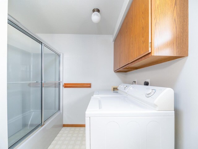 N6741 S Center Rd, Beaver Dam, WI 53916 - washroom featuring independent washer and dryer, cabinet space, light floors, and baseboards