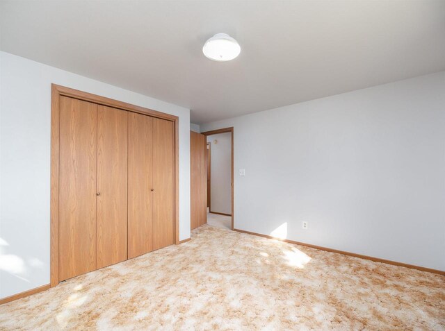 N6741 S Center Rd, Beaver Dam, WI 53916 - unfurnished bedroom featuring carpet floors, baseboards, and a closet