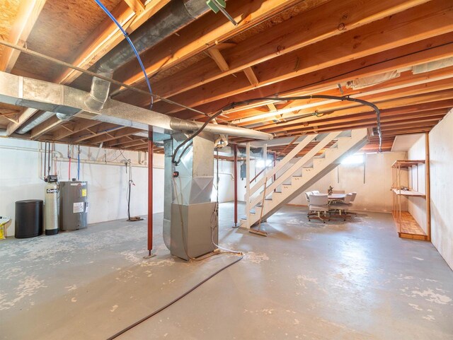 N6741 S Center Rd, Beaver Dam, WI 53916 - unfinished below grade area featuring water heater, stairs, and heating unit
