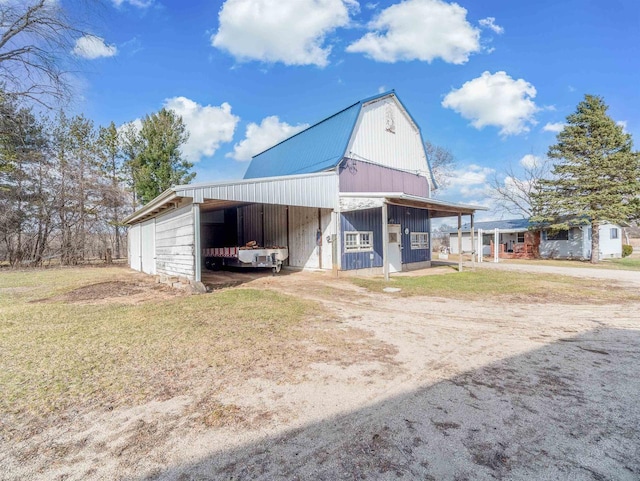 N6741 S Center Rd, Beaver Dam, WI 53916 - view of barn featuring dirt driveway and a carport