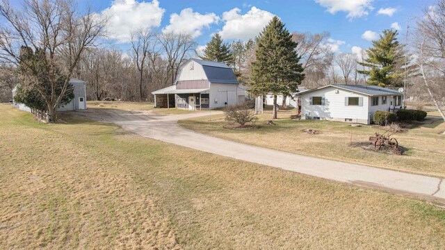 N6741 S Center Rd, Beaver Dam, WI 53916 - exterior space with driveway, a front yard, an outdoor structure, and a barn