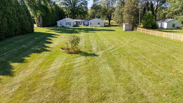 2548 Wallace Lake Rd, West Bend, WI 53090 - view of yard featuring a storage unit, an outbuilding, and fence