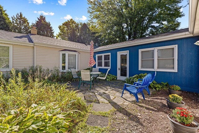 2548 Wallace Lake Rd, West Bend, WI 53090 - rear view of house with a chimney and a patio