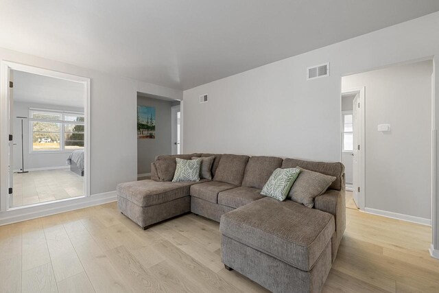 2548 Wallace Lake Rd, West Bend, WI 53090 - living area featuring baseboards, visible vents, and light wood-type flooring
