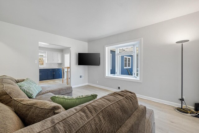 2548 Wallace Lake Rd, West Bend, WI 53090 - living room with baseboards, visible vents, and light wood-style floors
