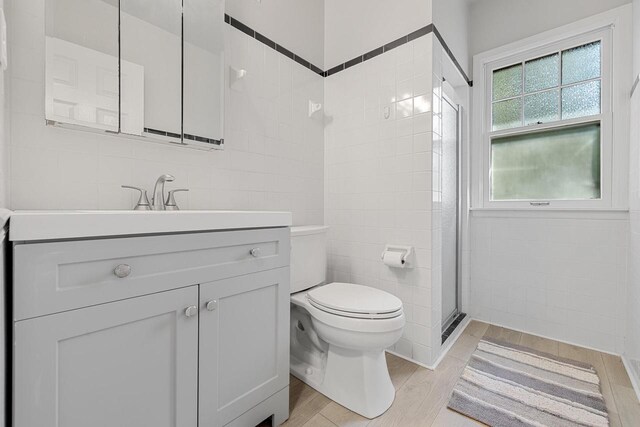 2548 Wallace Lake Rd, West Bend, WI 53090 - bathroom featuring wood finished floors, vanity, and tile walls