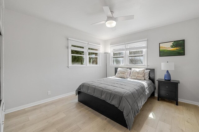 2548 Wallace Lake Rd, West Bend, WI 53090 - bedroom with a ceiling fan, light wood-style flooring, and baseboards