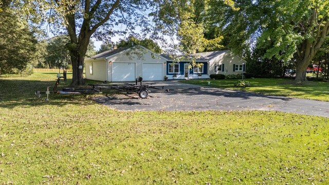 2548 Wallace Lake Rd, West Bend, WI 53090 - ranch-style house featuring driveway, a garage, and a front lawn