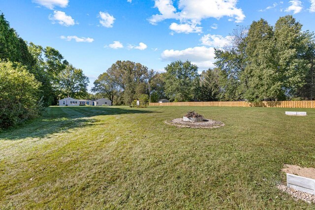 2548 Wallace Lake Rd, West Bend, WI 53090 - view of yard featuring fence and an outdoor fire pit