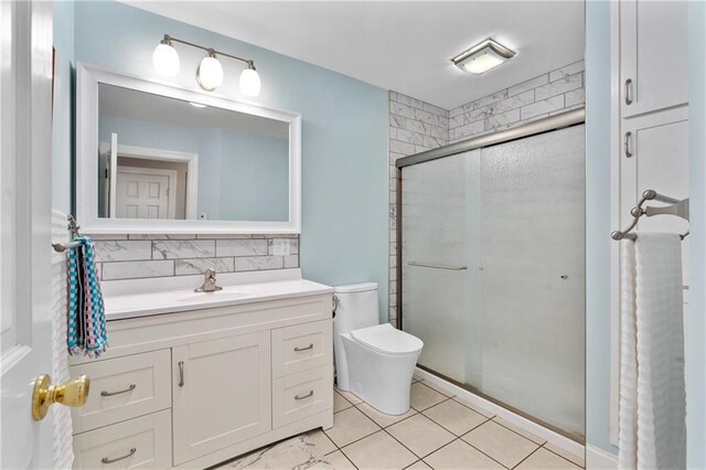 7822 Blue Valley Dr, Eau Claire, WI 54703 - bathroom with tile patterned flooring, vanity, toilet, decorative backsplash, and a shower stall