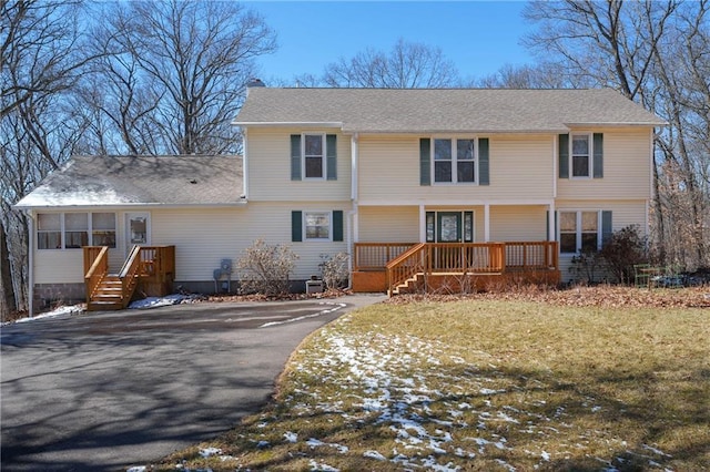 7822 Blue Valley Dr, Eau Claire, WI 54703 - colonial inspired home with a sunroom, roof with shingles, aphalt driveway, a front yard, and a porch