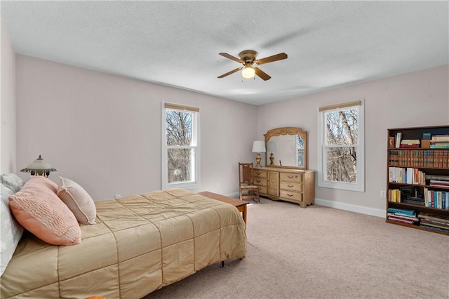 7822 Blue Valley Dr, Eau Claire, WI 54703 - carpeted bedroom featuring a ceiling fan, baseboards, multiple windows, and a textured ceiling