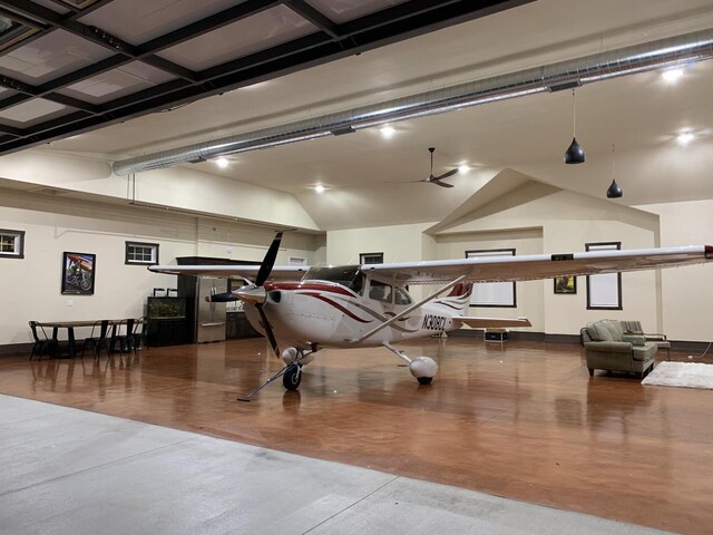 interior space with baseboards, concrete flooring, and a ceiling fan