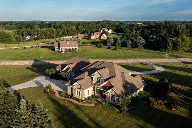 birds eye view of property featuring a wooded view