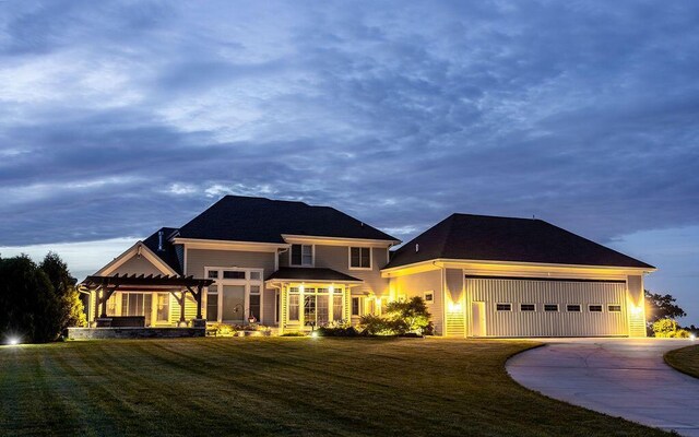 view of front of home featuring a pergola, a front yard, a garage, and concrete driveway