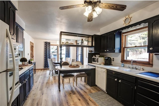 E5512 784th Ave, Menomonie, WI 54751 - kitchen featuring light countertops, a sink, white appliances, light wood-style floors, and ceiling fan