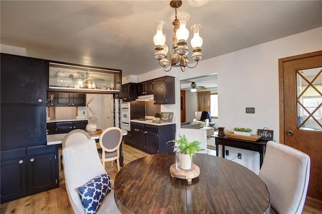 E5512 784th Ave, Menomonie, WI 54751 - dining room featuring light wood finished floors and ceiling fan with notable chandelier