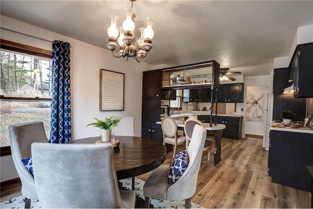 E5512 784th Ave, Menomonie, WI 54751 - dining area featuring ceiling fan with notable chandelier and light wood-style floors