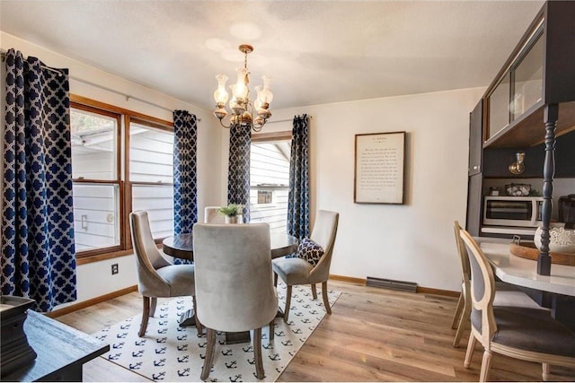 E5512 784th Ave, Menomonie, WI 54751 - dining room with an inviting chandelier, baseboards, and light wood finished floors