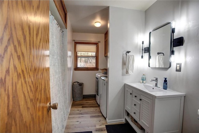 E5512 784th Ave, Menomonie, WI 54751 - bathroom featuring baseboards, separate washer and dryer, wood finished floors, and vanity