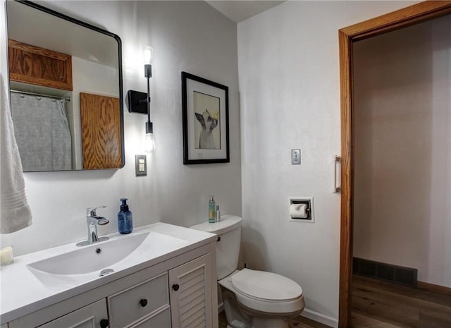 E5512 784th Ave, Menomonie, WI 54751 - bathroom with vanity, toilet, baseboards, visible vents, and wood finished floors