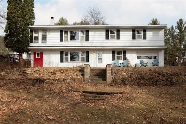 E5512 784th Ave, Menomonie, WI 54751 - traditional home with an attached garage and a chimney