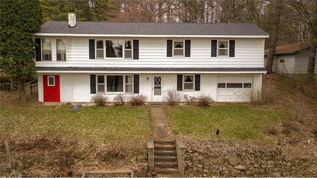 E5512 784th Ave, Menomonie, WI 54751 - view of front facade with a chimney, a garage, a front yard, and roof with shingles