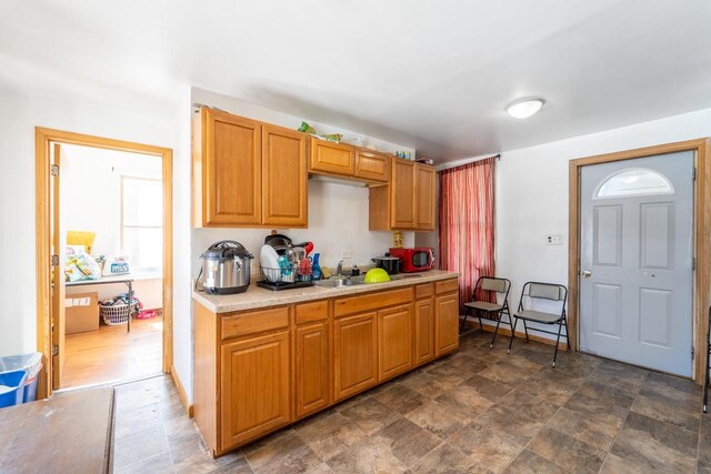 430 N 2nd Ave, Wausau, WI 54401 - kitchen featuring baseboards, light countertops, a sink, and stone finish flooring