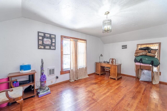 430 N 2nd Ave, Wausau, WI 54401 - office space with light wood-style flooring, visible vents, baseboards, an inviting chandelier, and vaulted ceiling