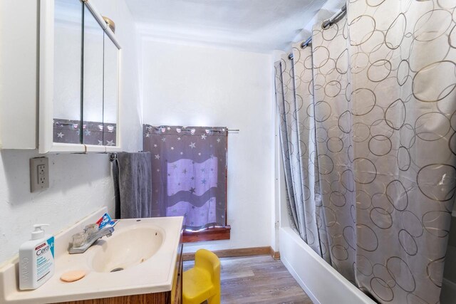 430 N 2nd Ave, Wausau, WI 54401 - full bath featuring vanity, shower / bath combo, baseboards, and wood finished floors