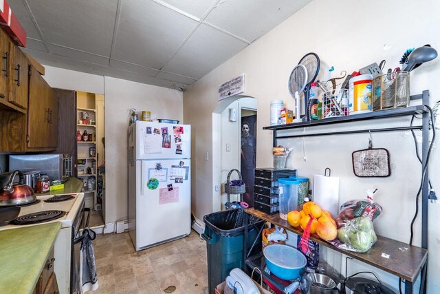 516 Hamilton St, Wausau, WI 54403 - kitchen with white appliances, brown cabinetry, light floors, and open shelves