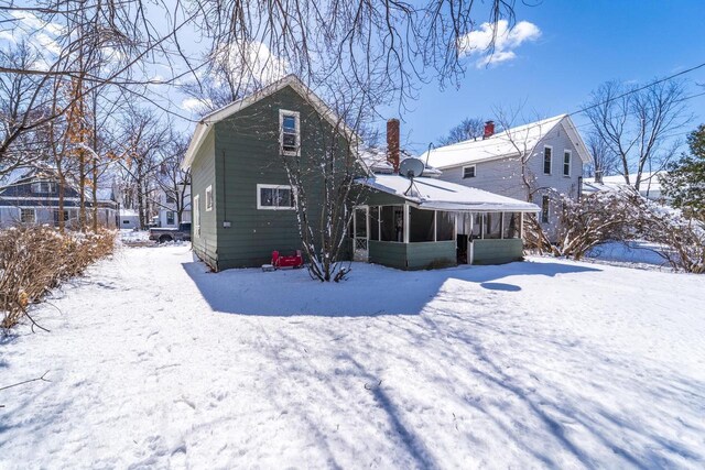 516 Hamilton St, Wausau, WI 54403 - snow covered back of property with a sunroom and a chimney