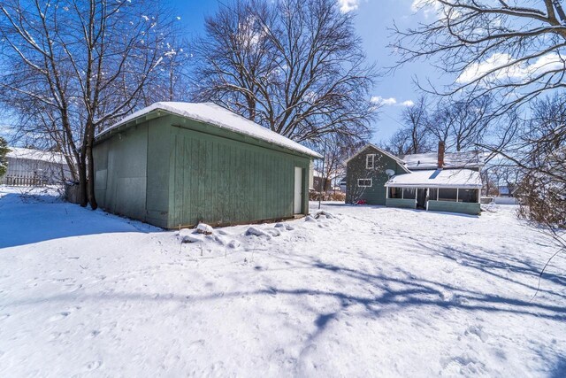 516 Hamilton St, Wausau, WI 54403 - snow covered structure featuring an outbuilding and a sunroom