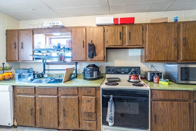 516 Hamilton St, Wausau, WI 54403 - kitchen with light countertops, stainless steel microwave, electric range, a sink, and white dishwasher