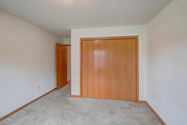 968 Pine St, Sun Prairie, WI 53590 - unfurnished bedroom with carpet flooring, baseboards, and a closet