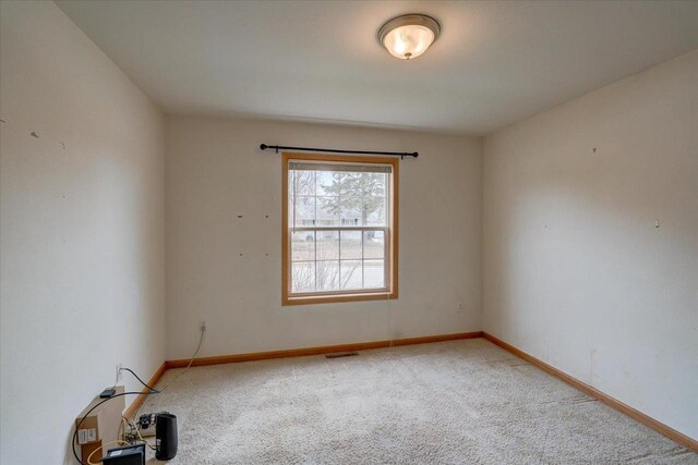 968 Pine St, Sun Prairie, WI 53590 - unfurnished room with baseboards, visible vents, and light colored carpet